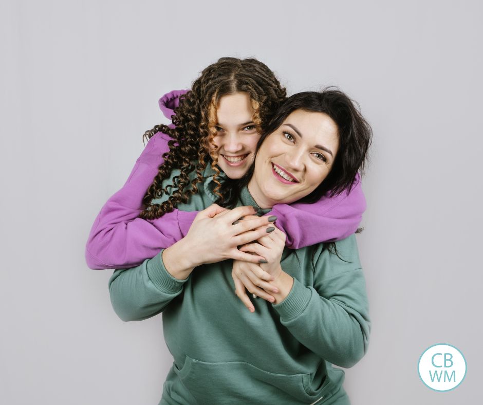 Daughter hugging mom from behind