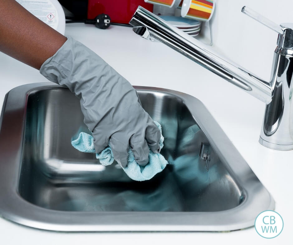 Picture showing the arm of a person cleaning out a sink