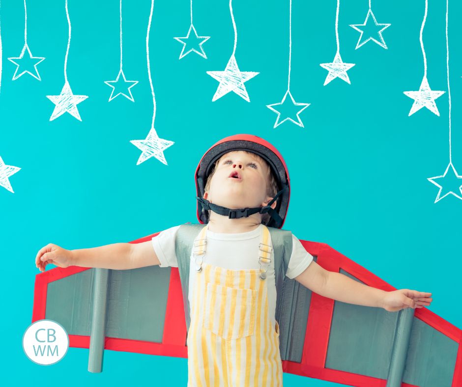 Child dressed up looking up into the air