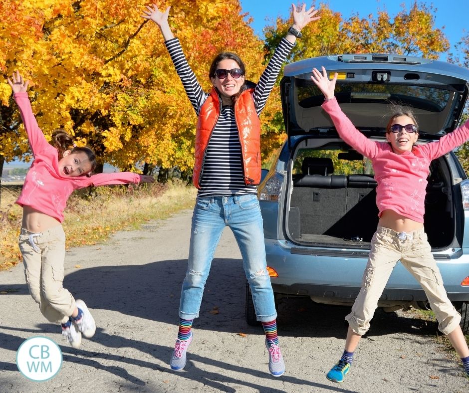 Mom celebrating with kids by jumping in air outside