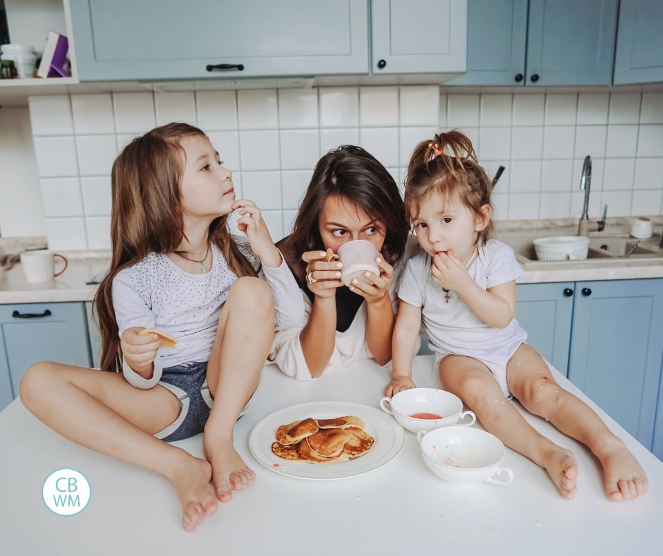 Mom and two kids. Kids are sitting on the counter