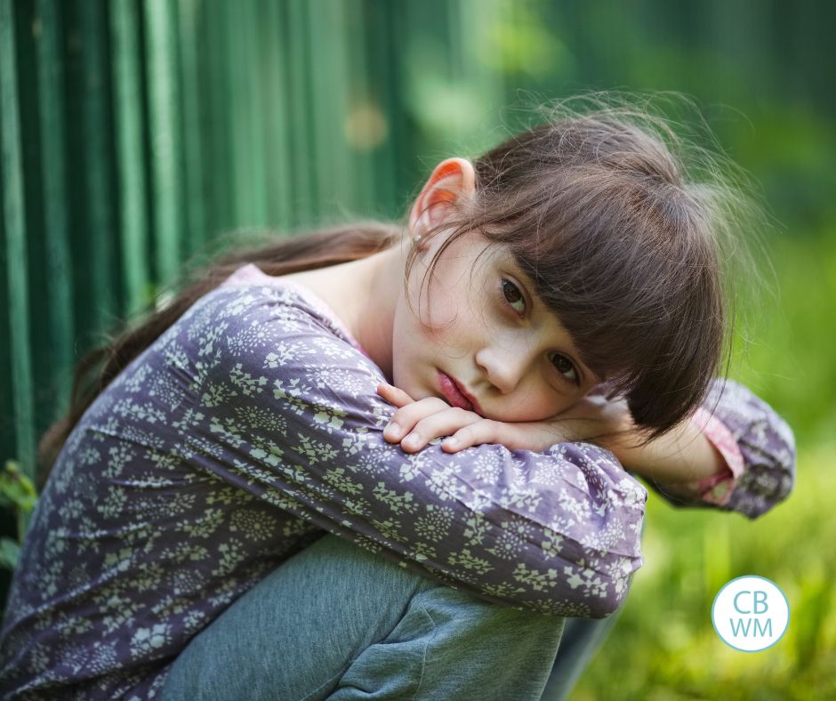 Girl squatted down who is sad