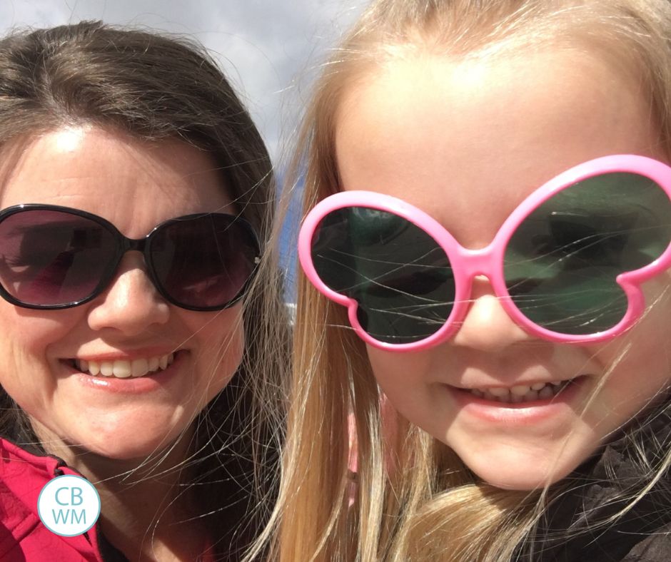 3.5 year old Brinley wearing butterfly glasses and her mom wearing normal sunglasses