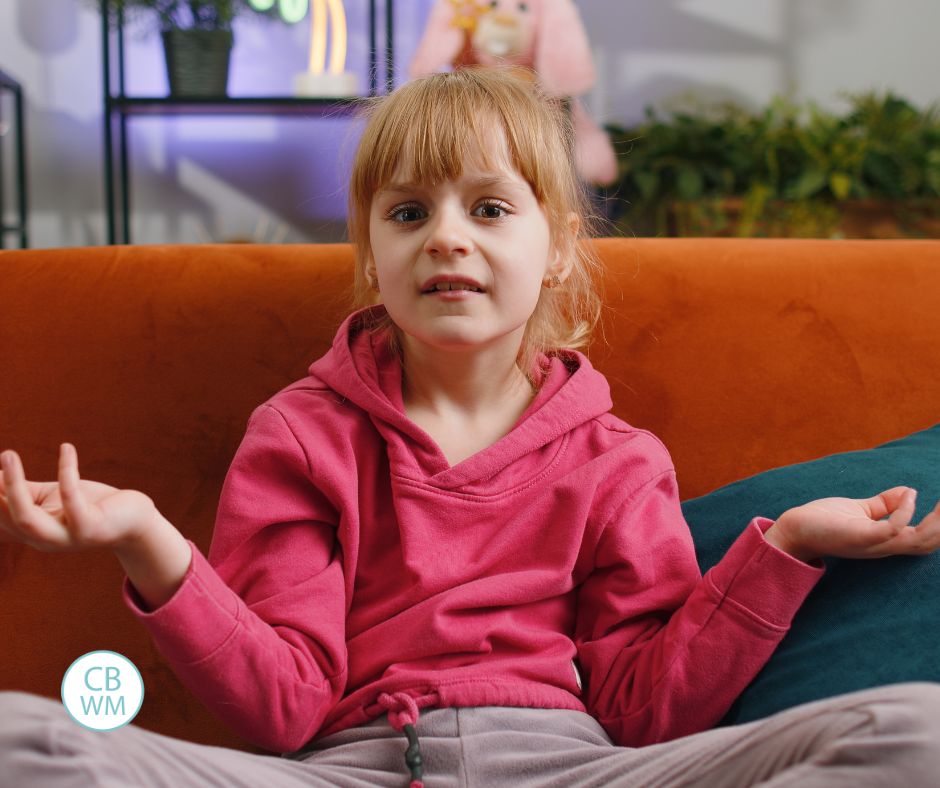 Child holding her hands out in a shrugging motion
