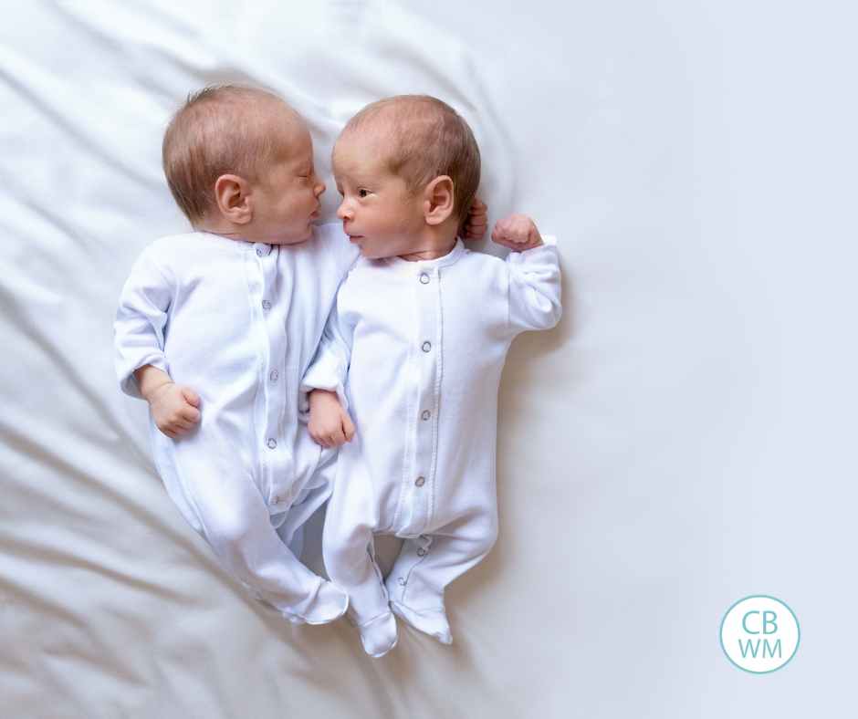 Twins lying down next to each other
