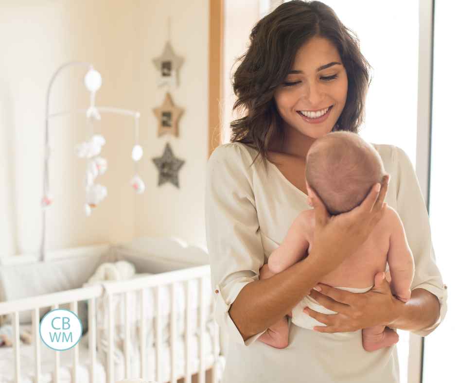A mom holding her baby in the nursery