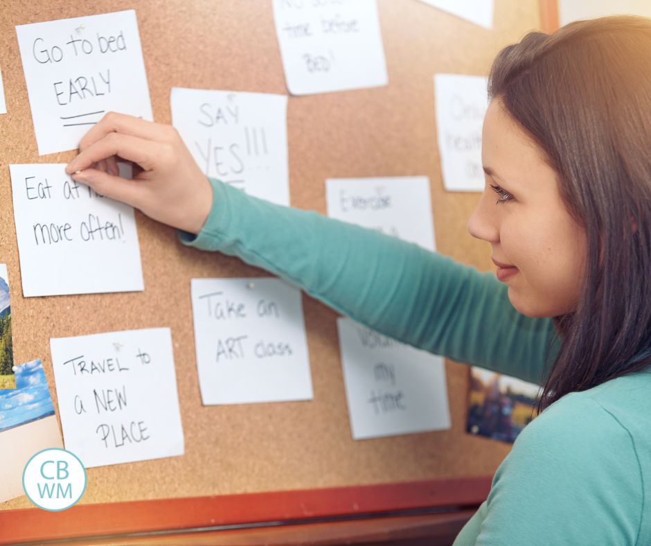Woman setting goals at a bulletin board