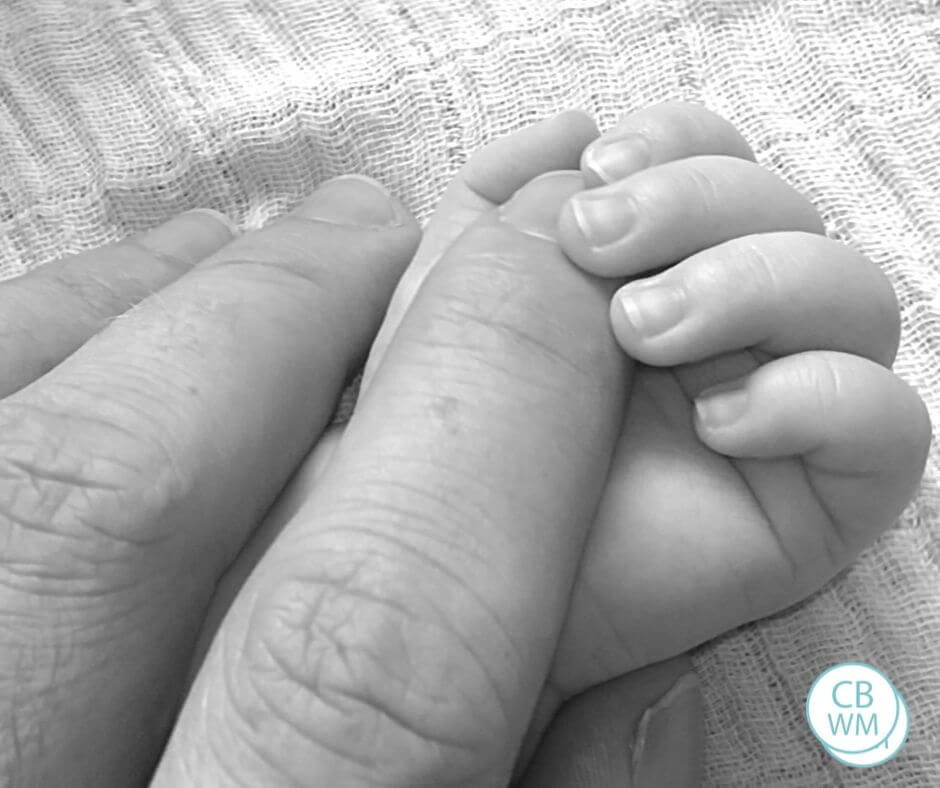Baby hand with parent fingers