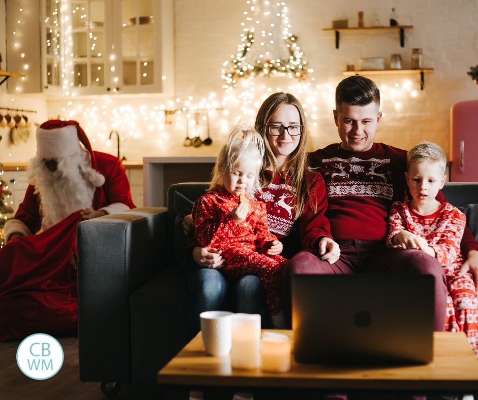 Family watching Christmas movies together with Santa behind them