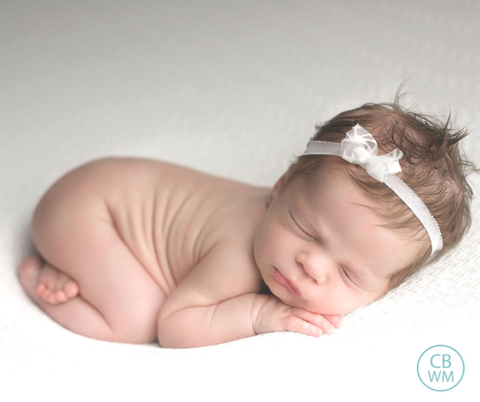 Baby sleeping on a white blanket