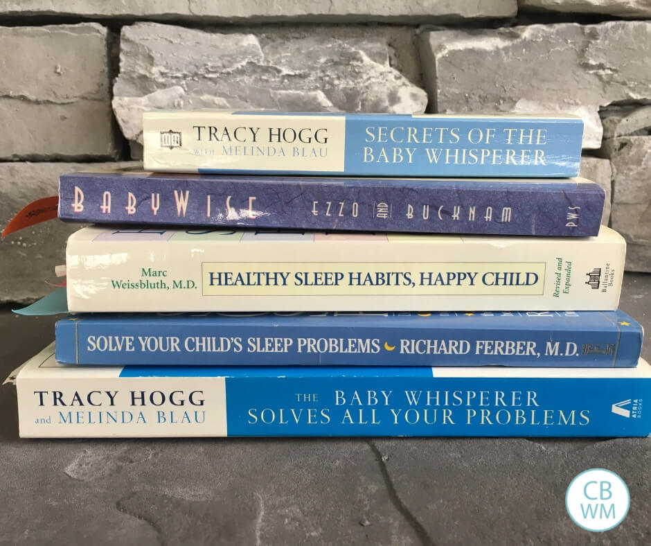 Sleep training books stacked up
