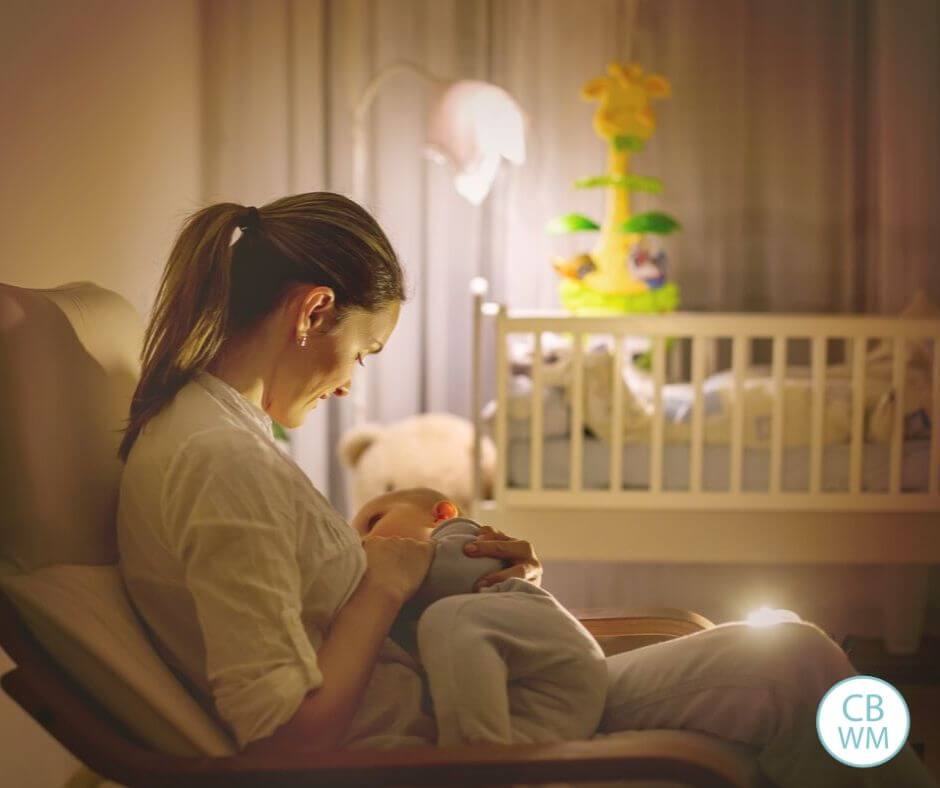 Mom breastfeeding baby at night