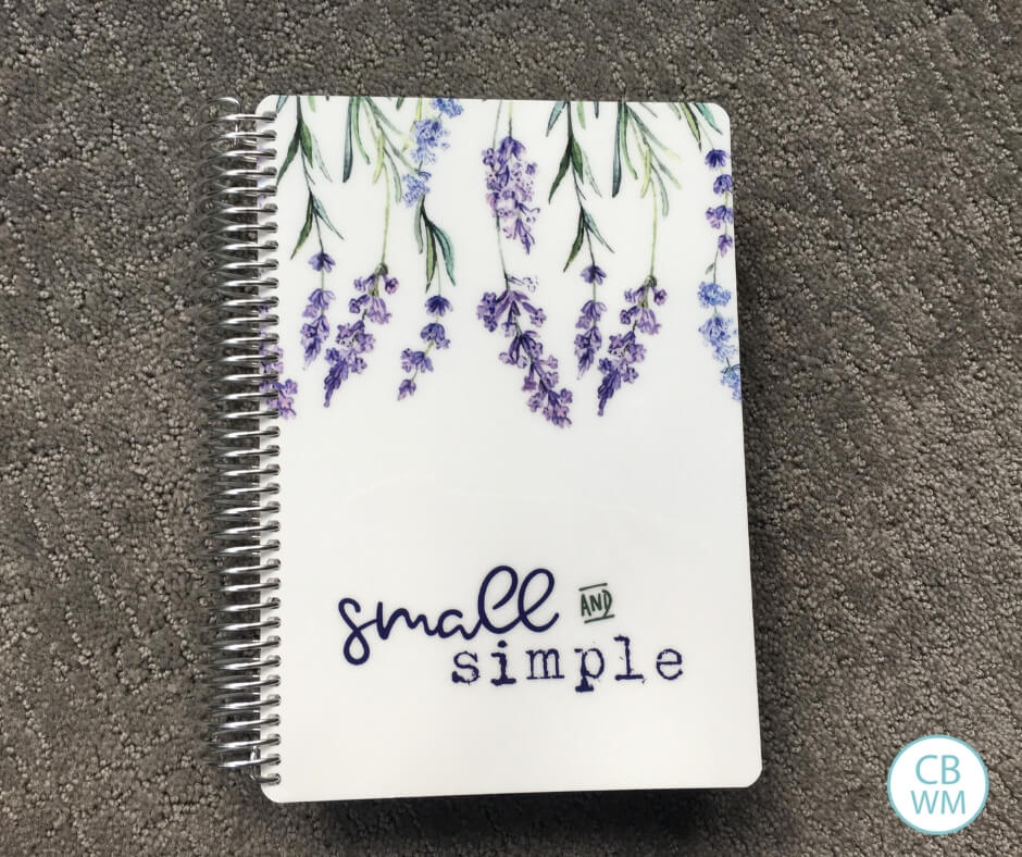 Spiral bound planner titled "Small and Simple" on a gray background.