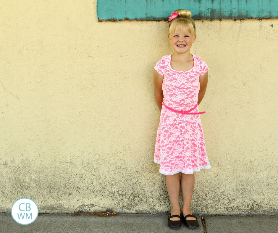 Blonde haired girl against a yellow wall