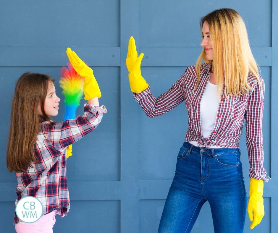 Mother teaching her daughter how to do chores