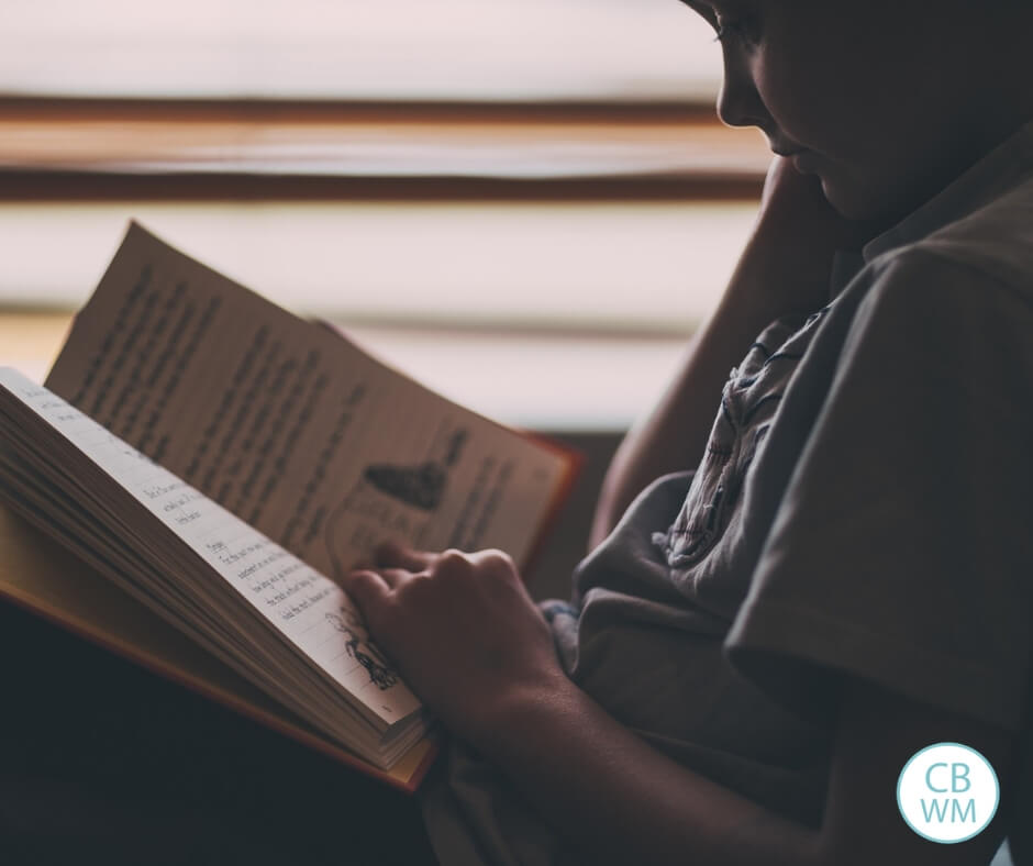 Child reading a book while resting