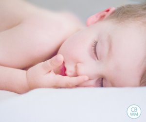 Sleeping toddler on a white bed
