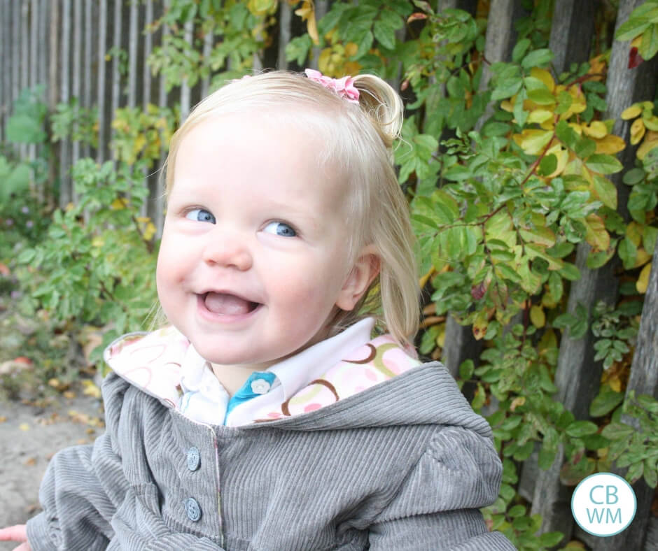 Toddler girl looking mischievous 