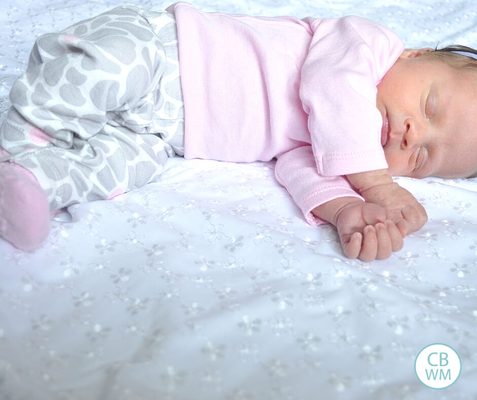 Baby laying on white blanket