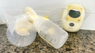Breastpump on agranite counter with a white backsplash