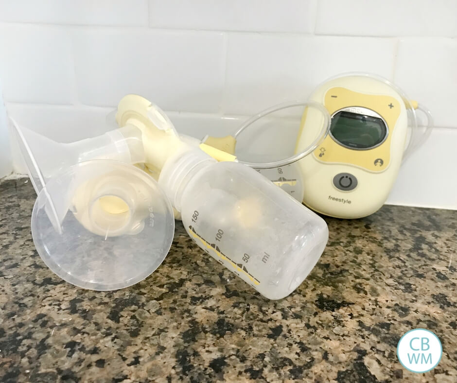 Breastpump on agranite counter with a white backsplash