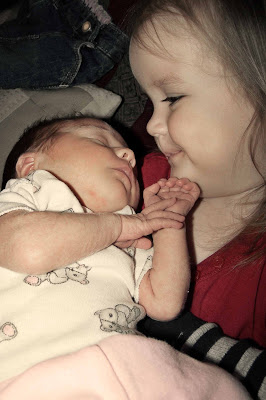 Girl holding a newborn Girl holding a newborn