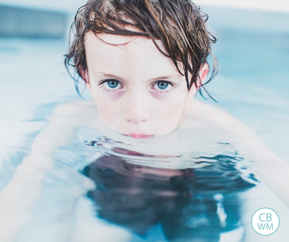 Boy with blue eyes staring at the camera while in the water