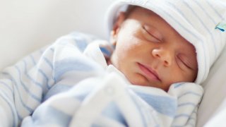 Baby sleeping in a striped sleeper