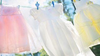 pink, white, and yellow dresses hanging on a clothesline