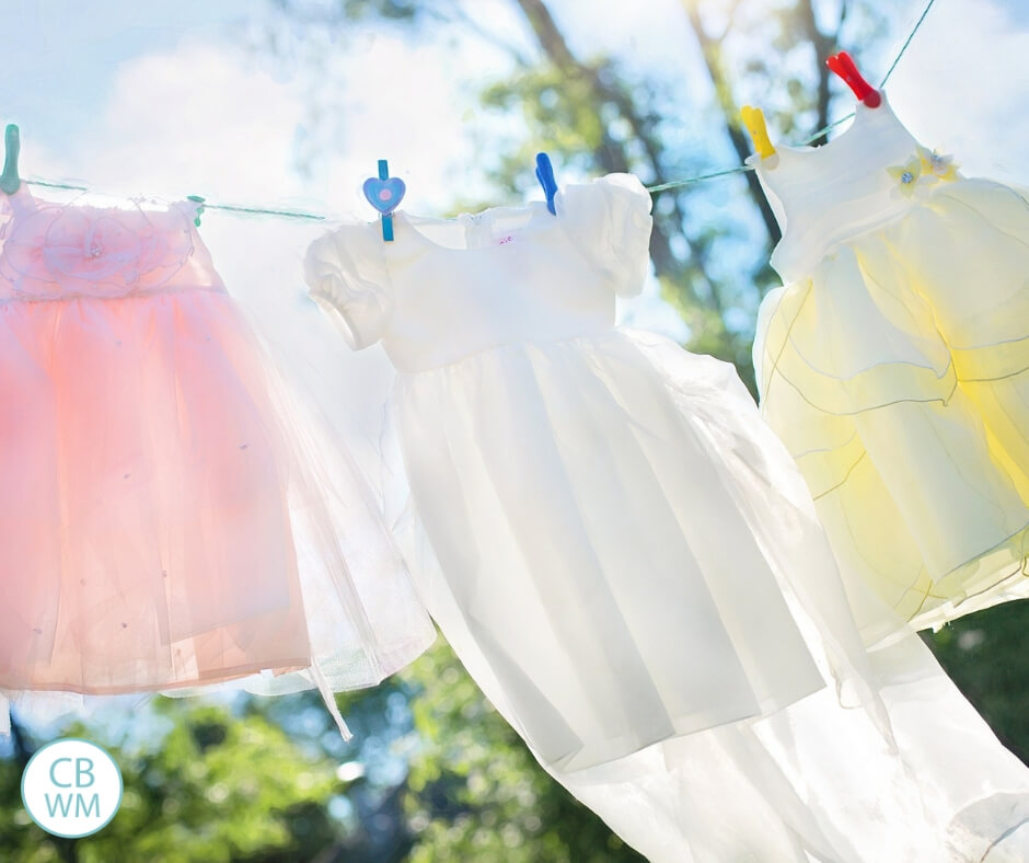pink, white, and yellow dresses hanging on a clothesline