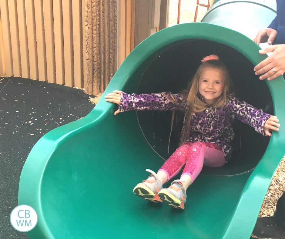 6 year old girl going down a tube slide