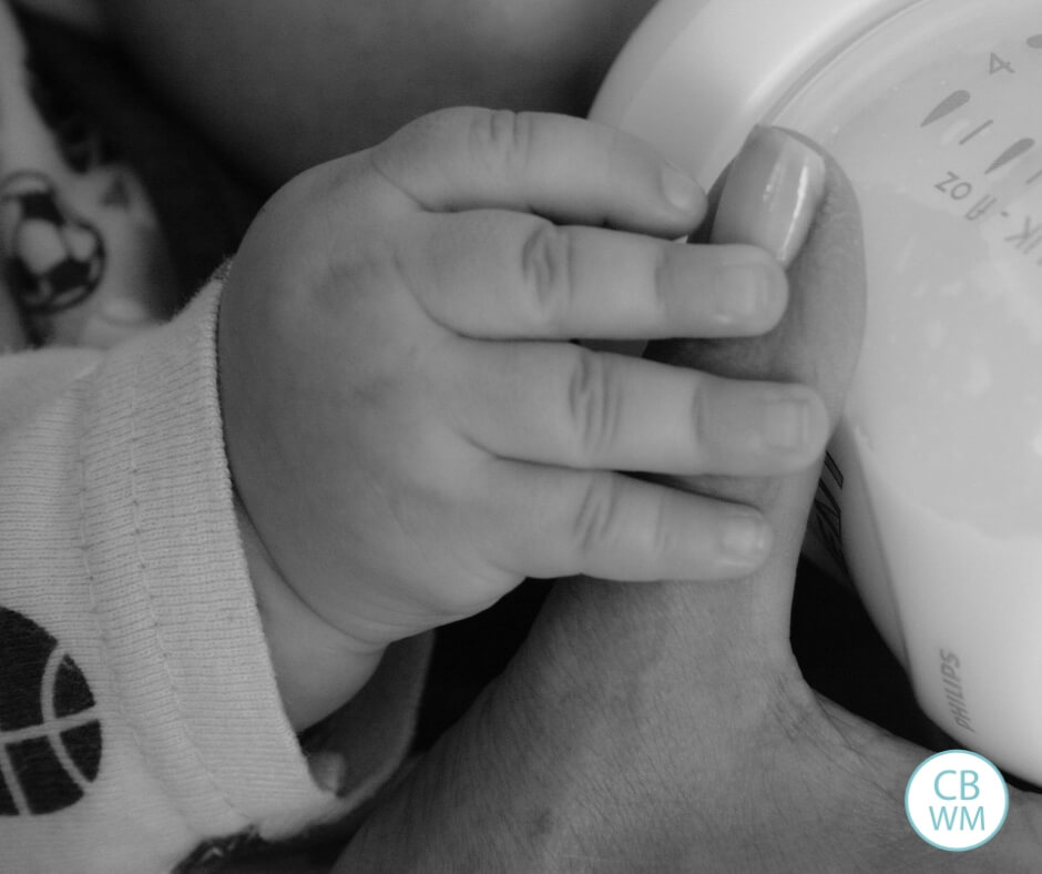 Bottle feeding baby in black and white