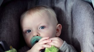 Baby in carseat looking sleepy