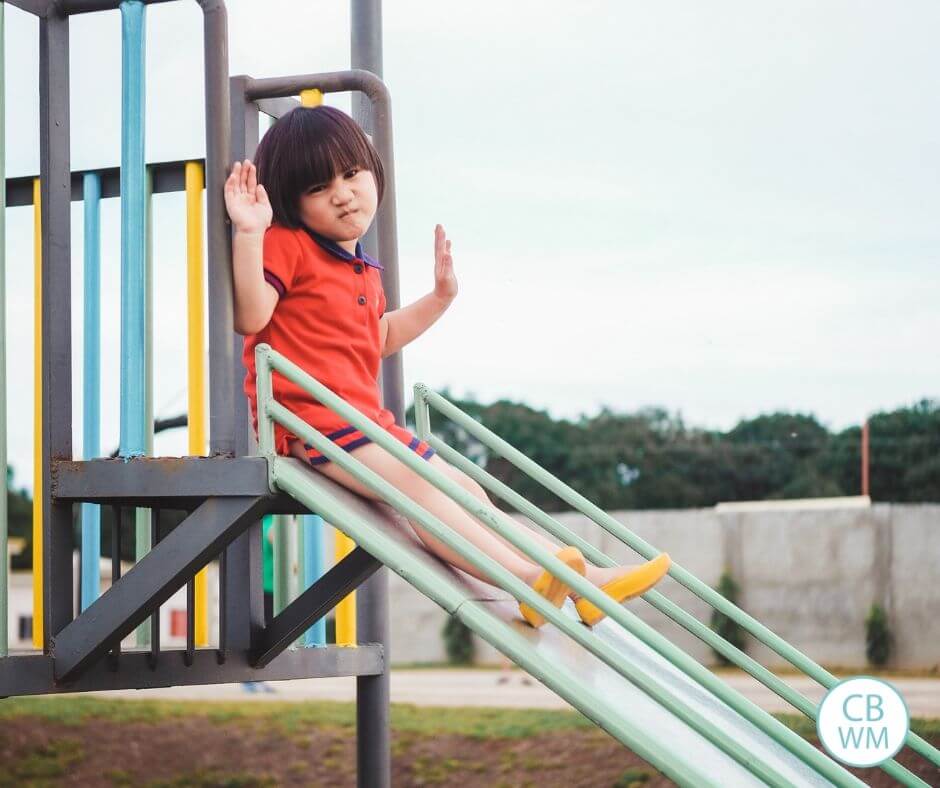 Child upset on a slide at a playground