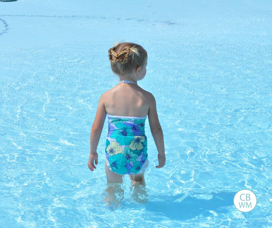 Brinley at the pool with her back to the camera