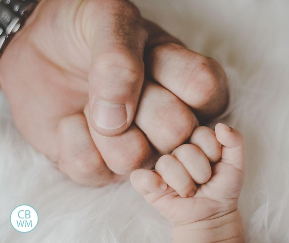 Baby fist bump between baby and parent