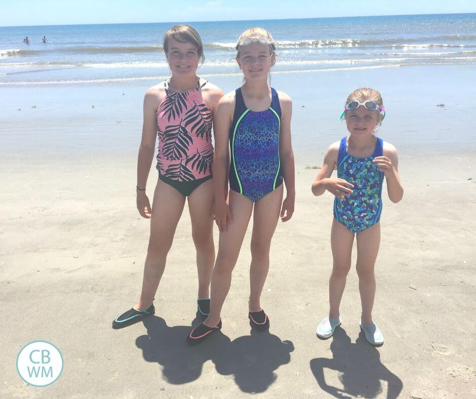 Three girls standing on the beach at Cocoa Beach, Florida