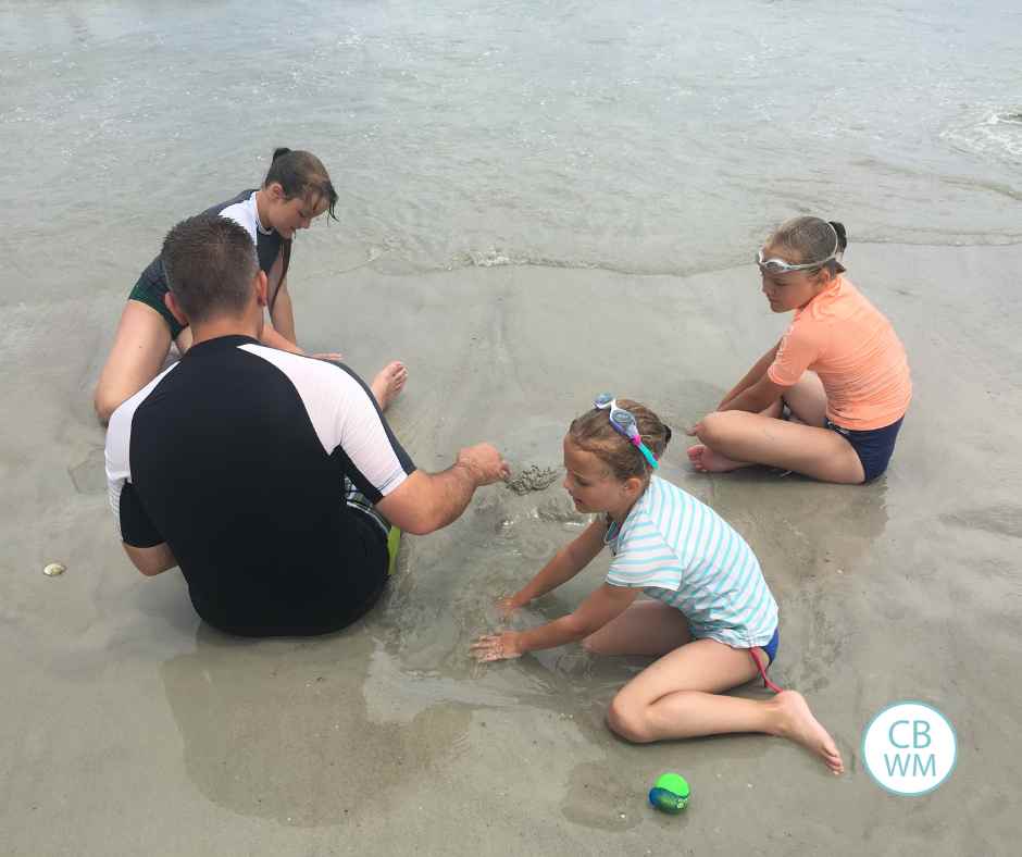 Nate and the girls playing in the sand at the beach