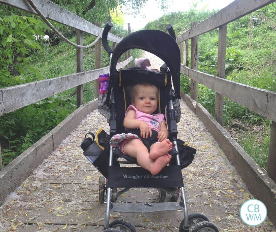 10 month old baby in a stroller on a bridge