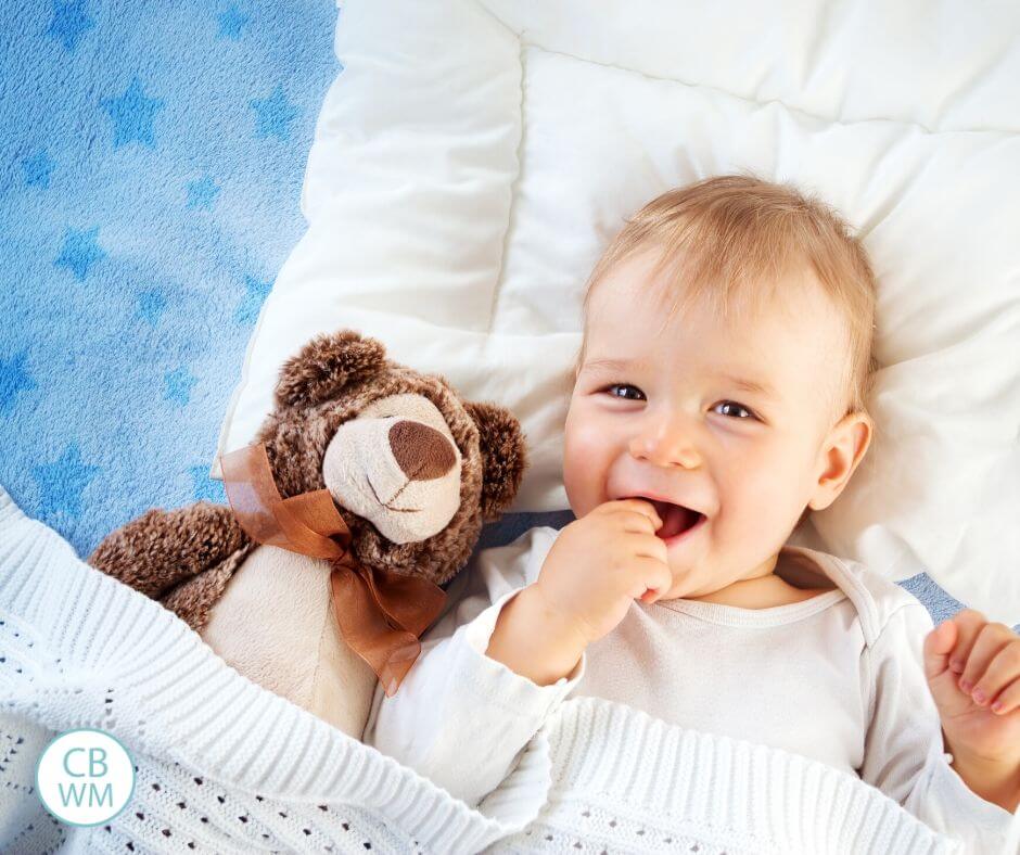 Pretoddler in bed smiling at camera