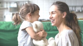 Mom talking to daughter at eye level