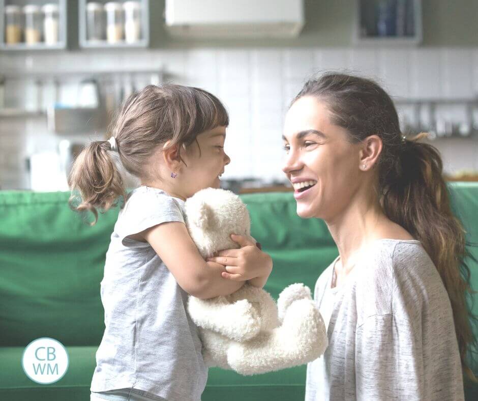 Mom talking to daughter at eye level