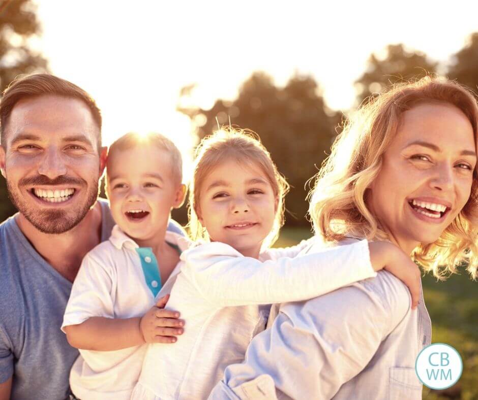 Happy family of four outside