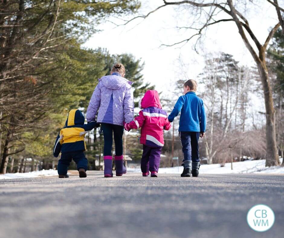 Four children walking down the road