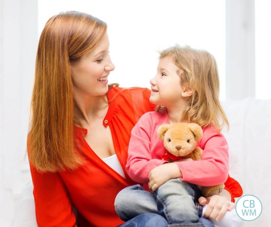 Mom and girl looking at each other and smiling