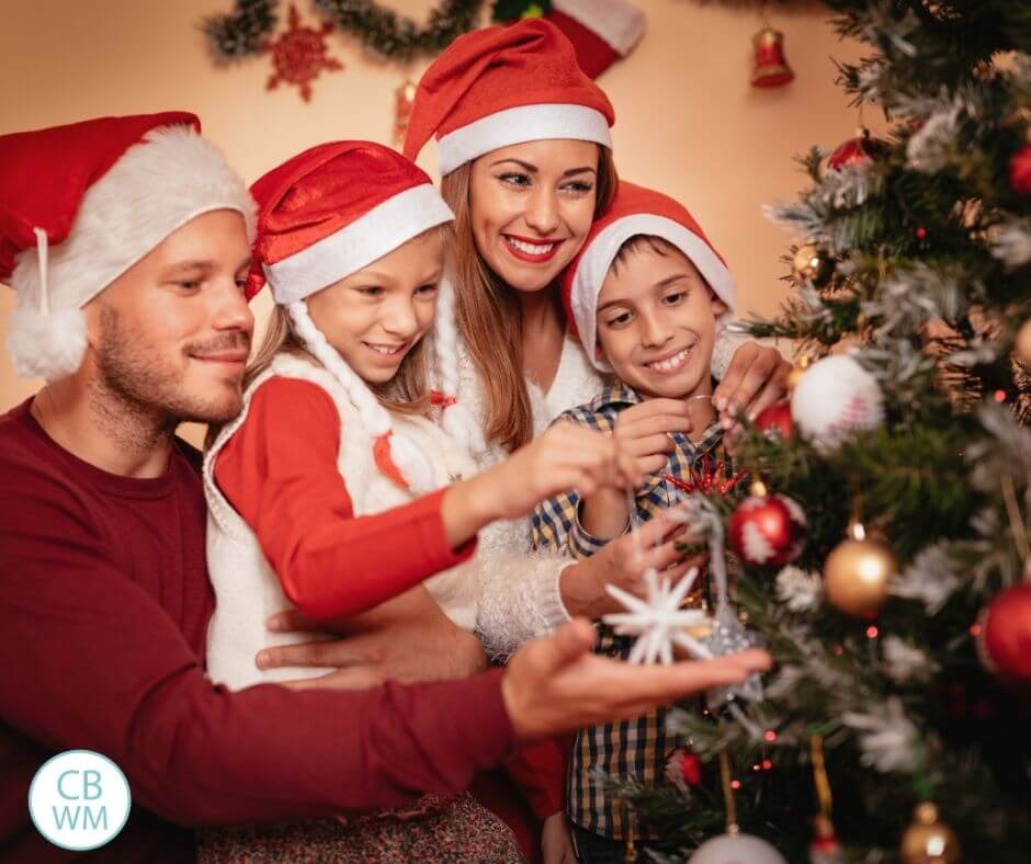 Family decorating a Christmas tree