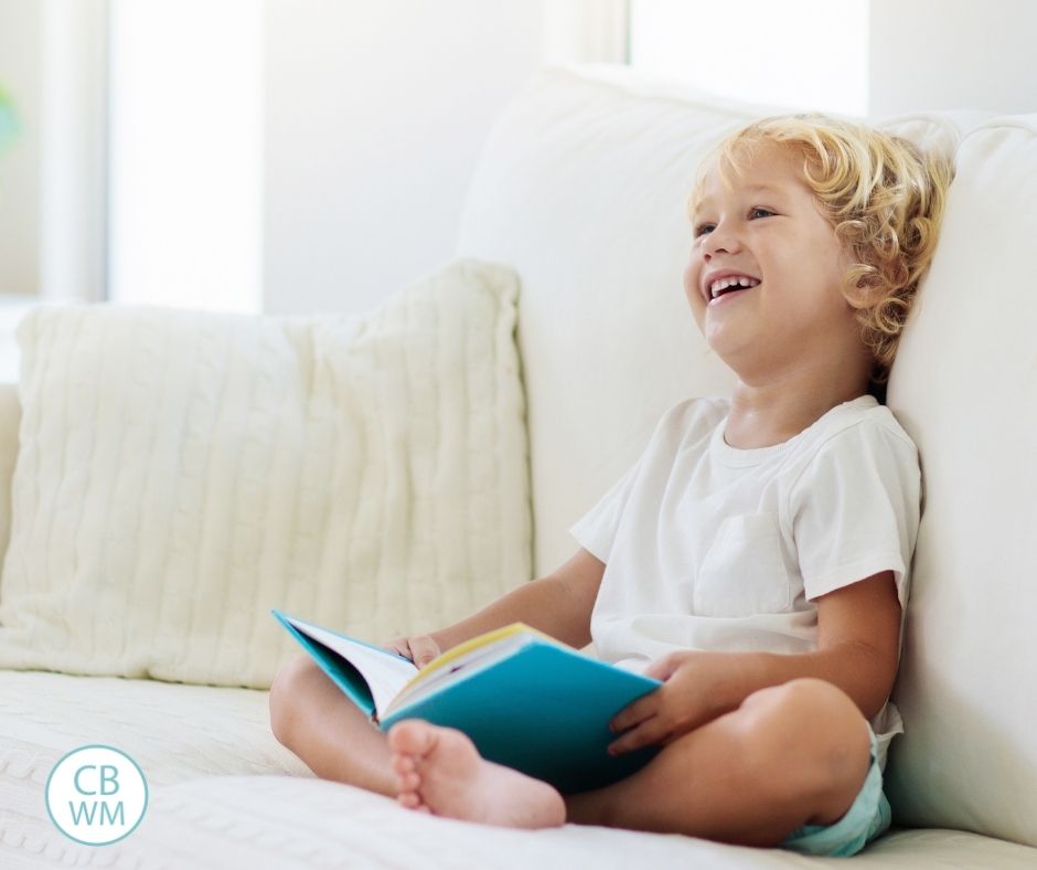 Child happily reading on the couch