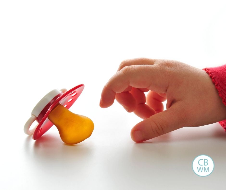 Child reaching for pacifier