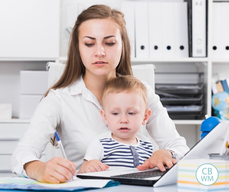 Mom creating schedule with toddler on her lap
