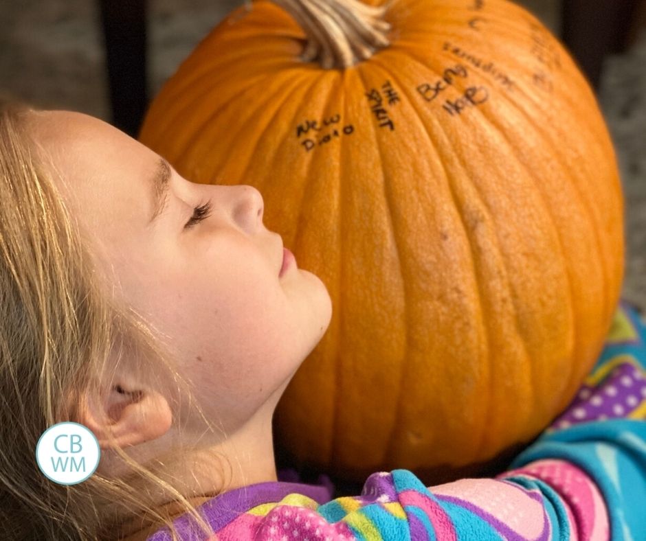 Brinley hugging the pumpkin